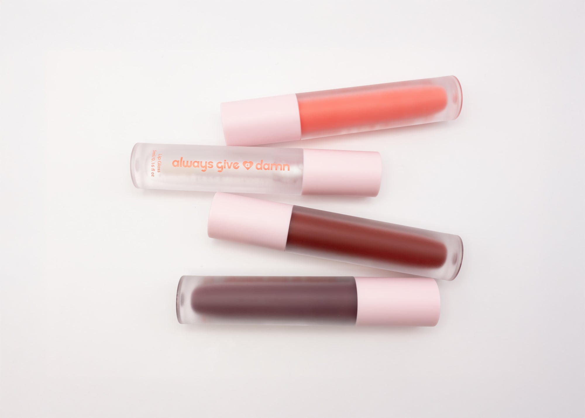 Four lip glosses featuring pink, clear, red, and purple